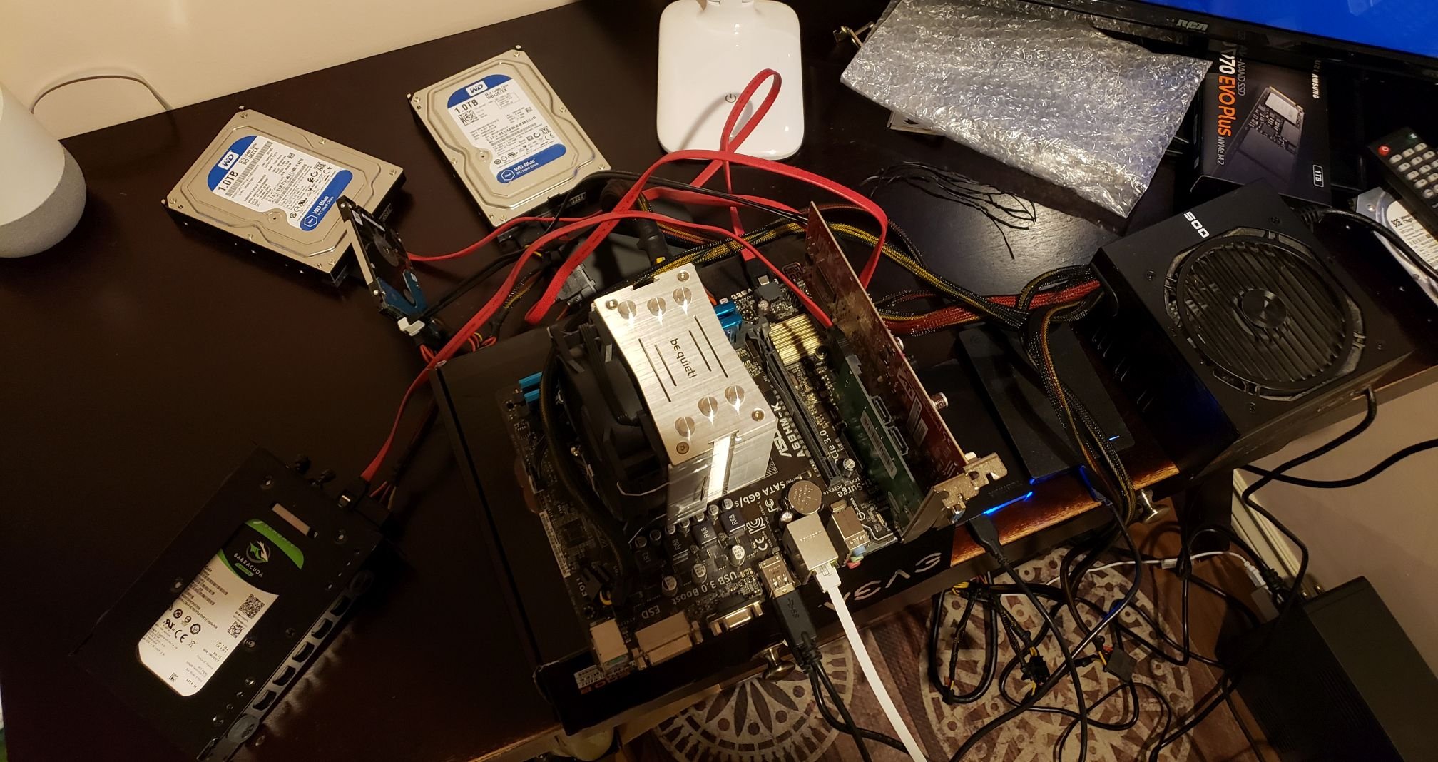 Motherboard and hard drives sitting on a desk